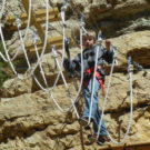 Young boy making his way across the rope walk Raft Masters Colorado