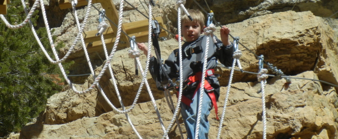 Young boy making his way across the rope walk Raft Masters Colorado