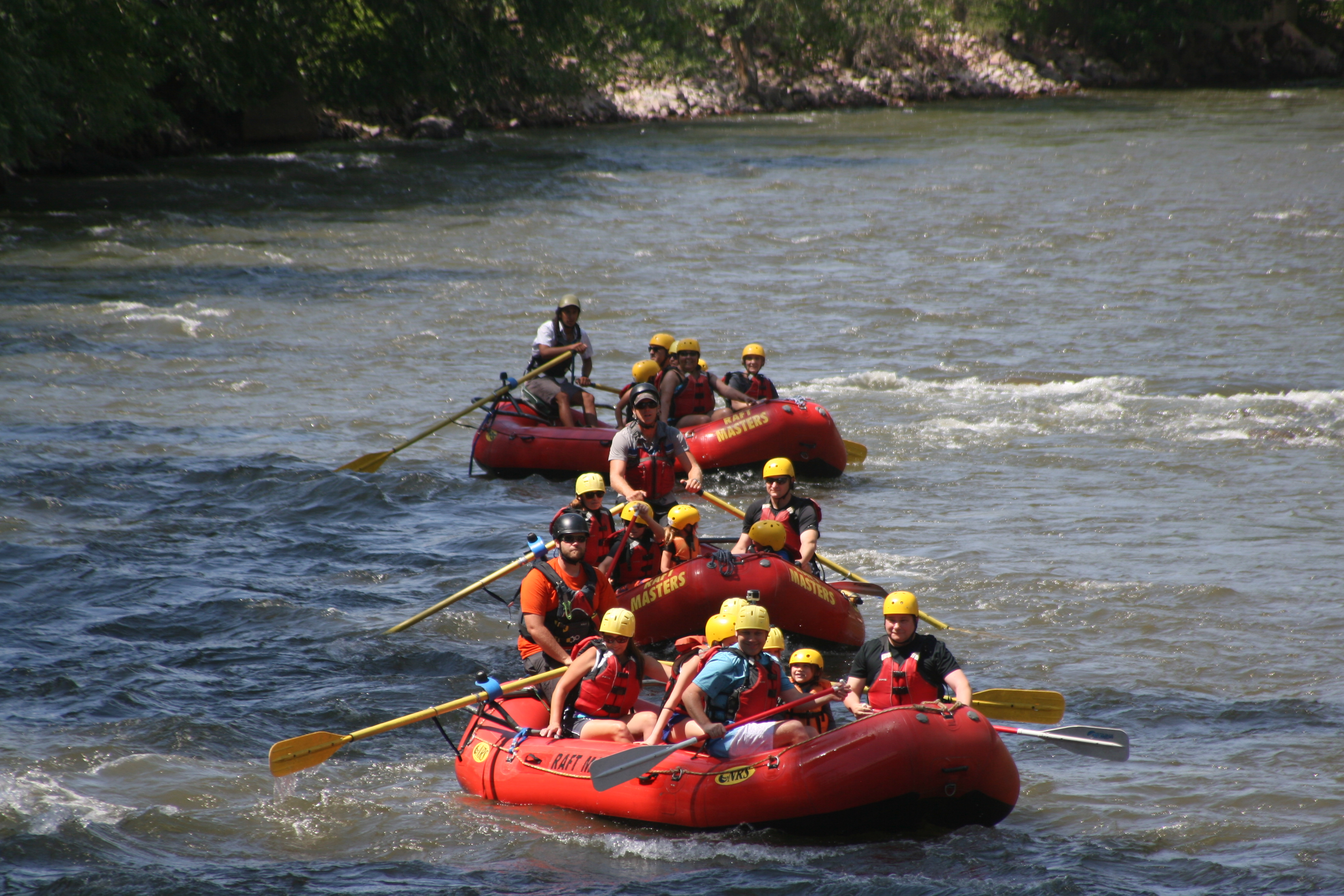 three rafts with families going down the river Raft Masters Colorado