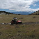 People driving in an ATV with mountains in background Raft Masters Tours Colorado