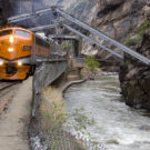 oncoming Royal Gorge train on tracks near river Raft Masters Colorado tour