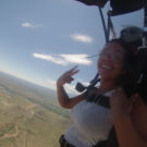 Jasmin skydiving giving a peace sign with fingers Raft Masters Tours Colorado