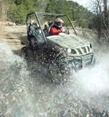 People in an ATV getting splashed by water Raft Masters Tours Colorado