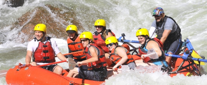 guests on raft having fun navigating rapids on the Arkansas river Raft Masters Tours Colorado