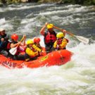 Raft with younger children going through rapids on Clear Creek Raft Masters Tours Colorado
