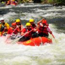 Raft with 5 guests and a guide going through rapids on Clear Creek Raft Masters Tours Colorado