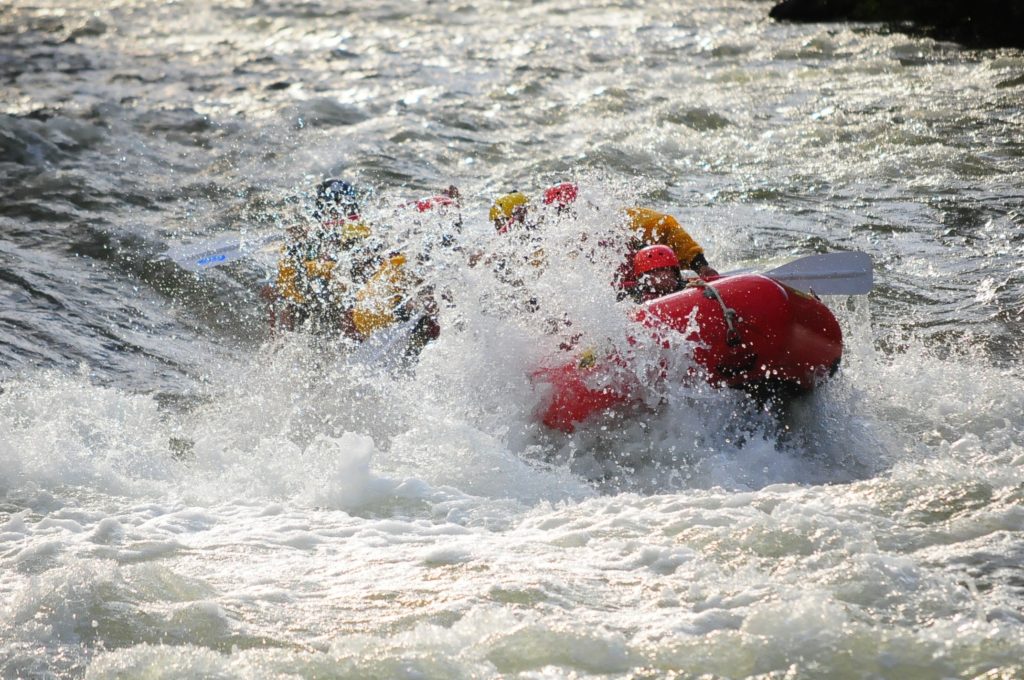 raft getting sprayed with water from rapids on Clear Creek Raft Masters Tours Colorado