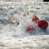 raft getting sprayed with water from rapids on Clear Creek Raft Masters Tours Colorado