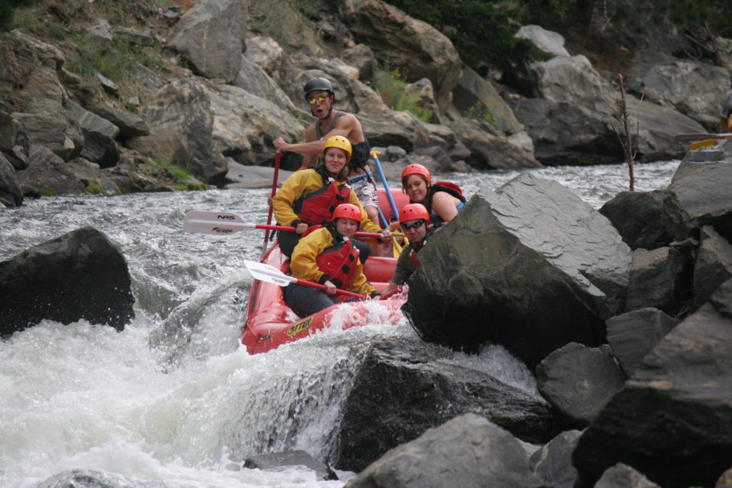 guests in raft navigating past rocks on Clear Creek Raft Masters Tours Colorado